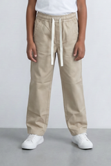Boy's beige drawstring pants with an elastic waist and casual fit from tomato store.