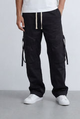 Men’s black utility cargo pants with waterproof flap pockets and cream drawstrings.
