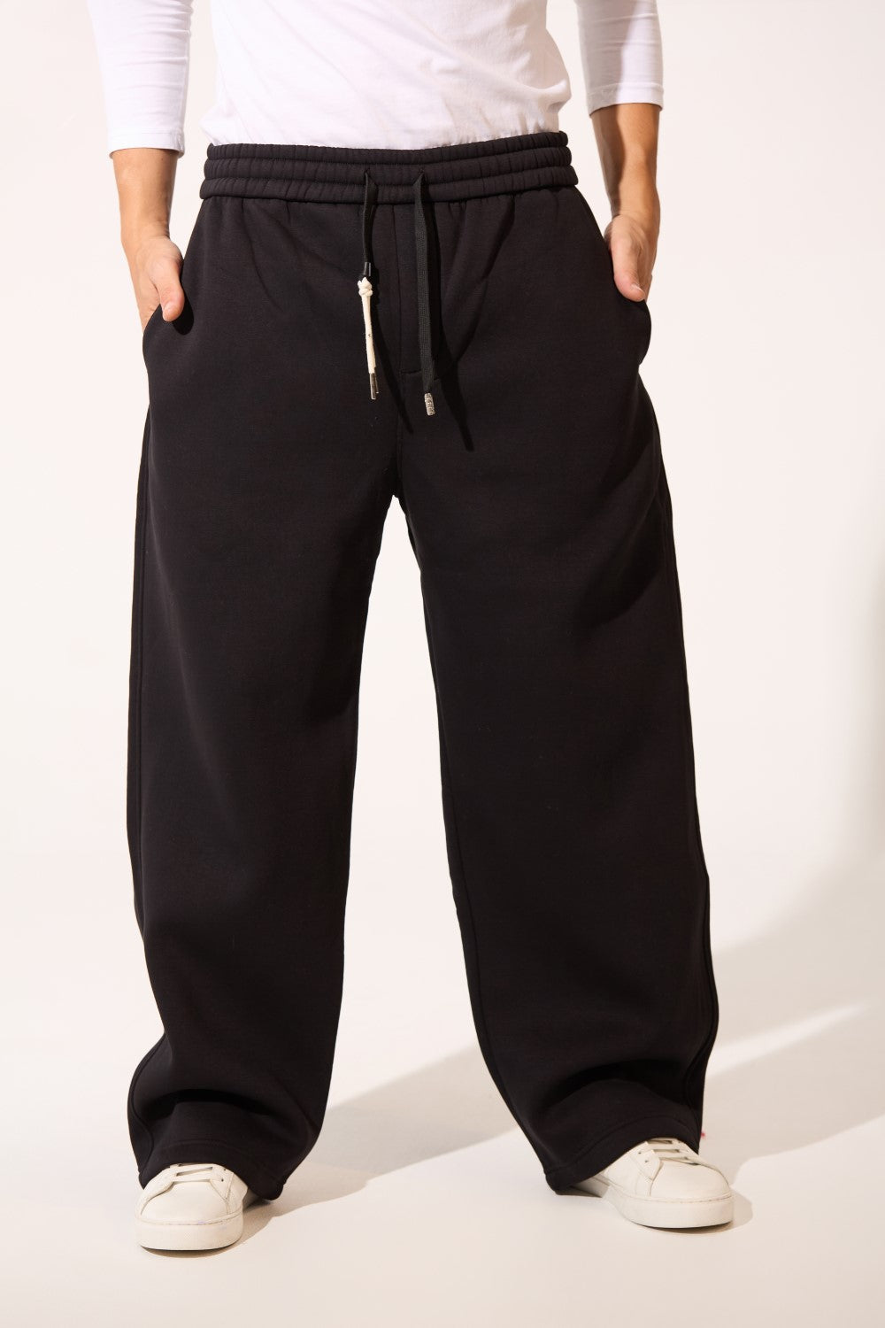 Men’s Core Street Sweatpants in black with a minimal oversize look and drawstring by tomato store.