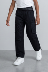 Boy's black cargo pants with an adjustable belt, utility pockets, and white sneakers.