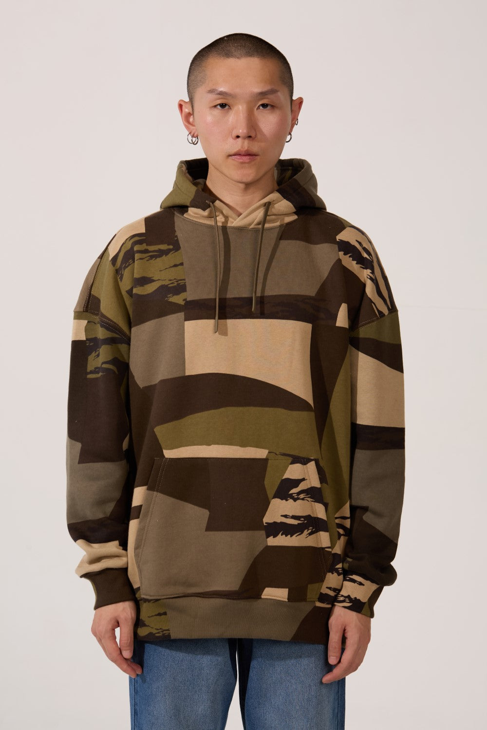 Army Regular Fit Men Hoodie by tomato store featuring a bold green and beige camo patchwork pattern.