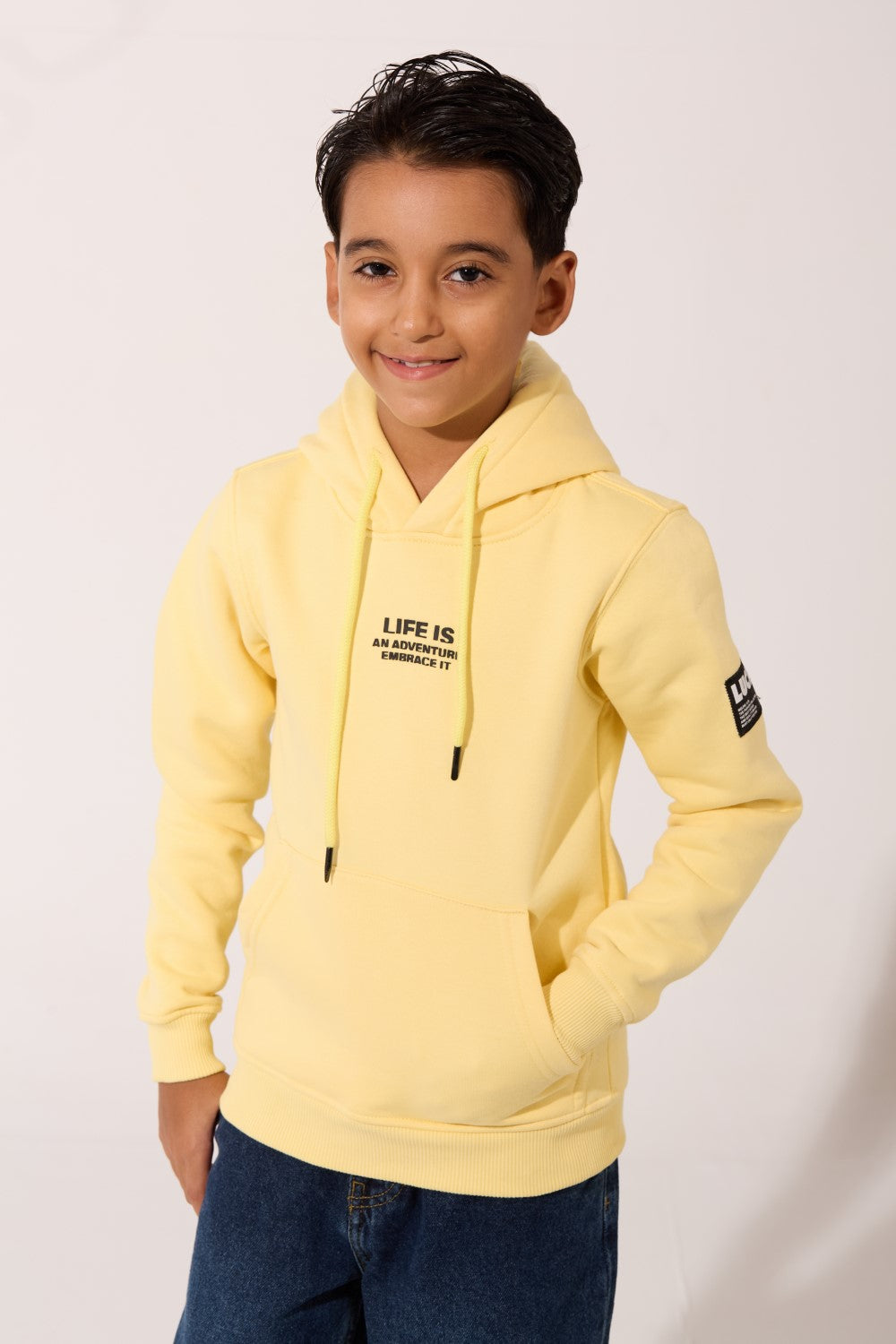 Boys Slim Fit Hoodie in yellow with 'LIFE IS AN ADVENTURE' text by tomato store.