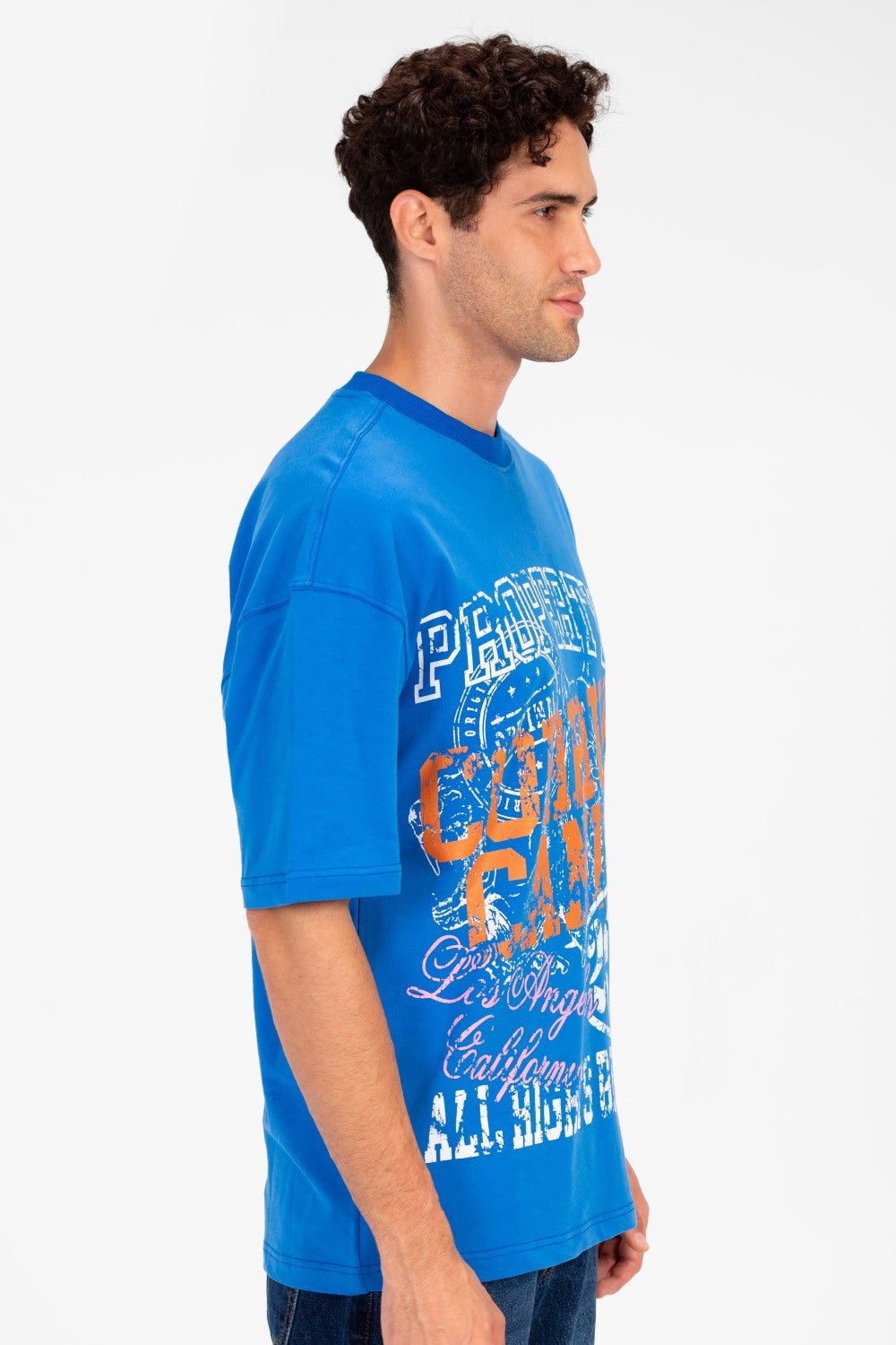 Men's blue oversized t-shirt with vintage college graphic artwork.