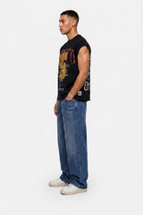 Man wearing a black graphic t-shirt, blue jeans, and white sneakers on a white background